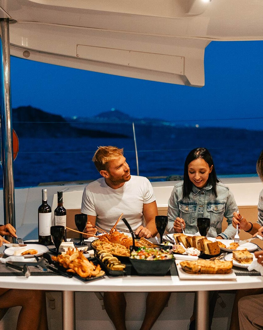 Friends having dinner on Santorini Sunset Cruise
