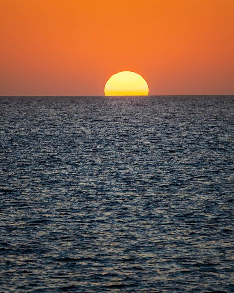 Santorini Sunset with Sun in Sea