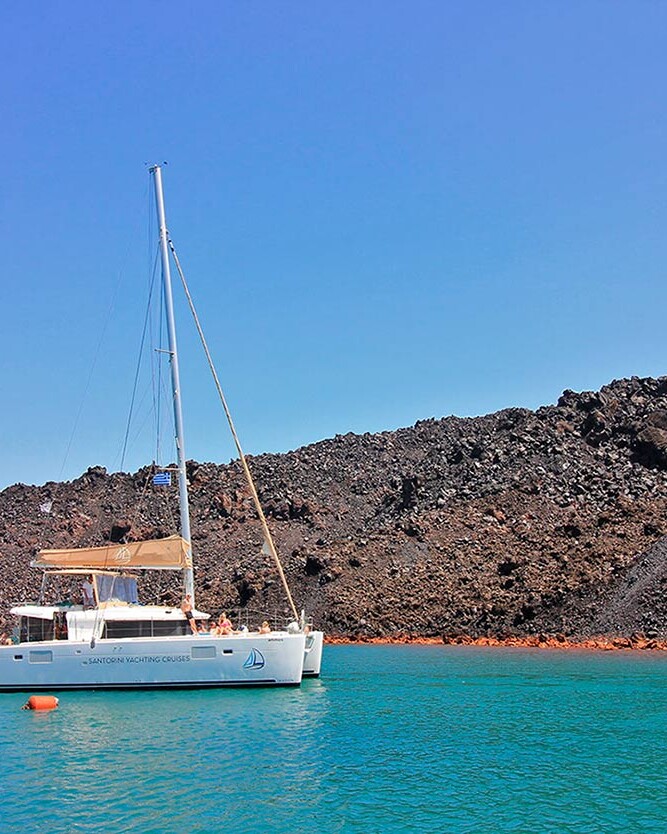 Catamaran in Santorini hot springs by the caldera