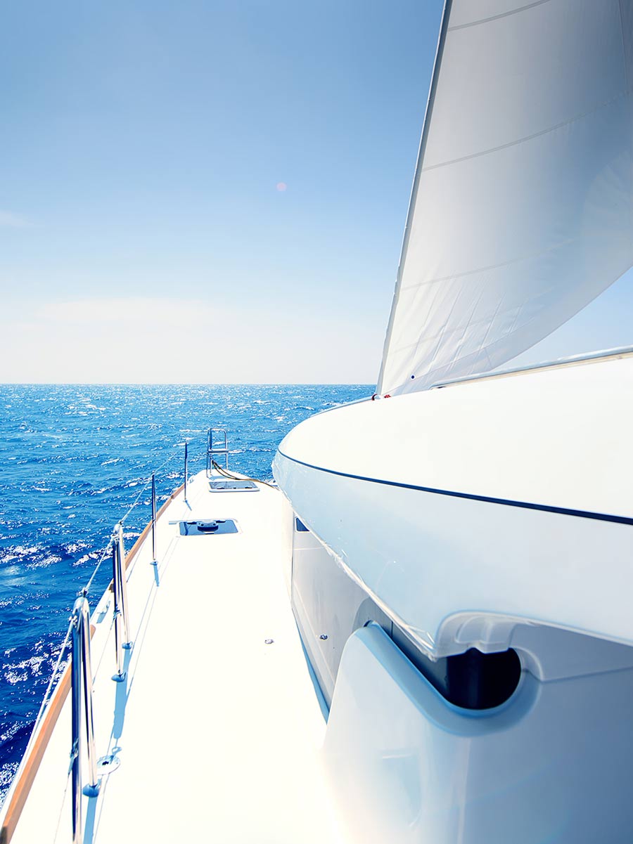 Santorini Catamaran with open sail during a sunny day in the Aegean sea