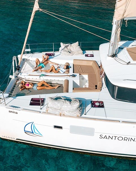 Friends sunbathing on Catamaran in Santorini