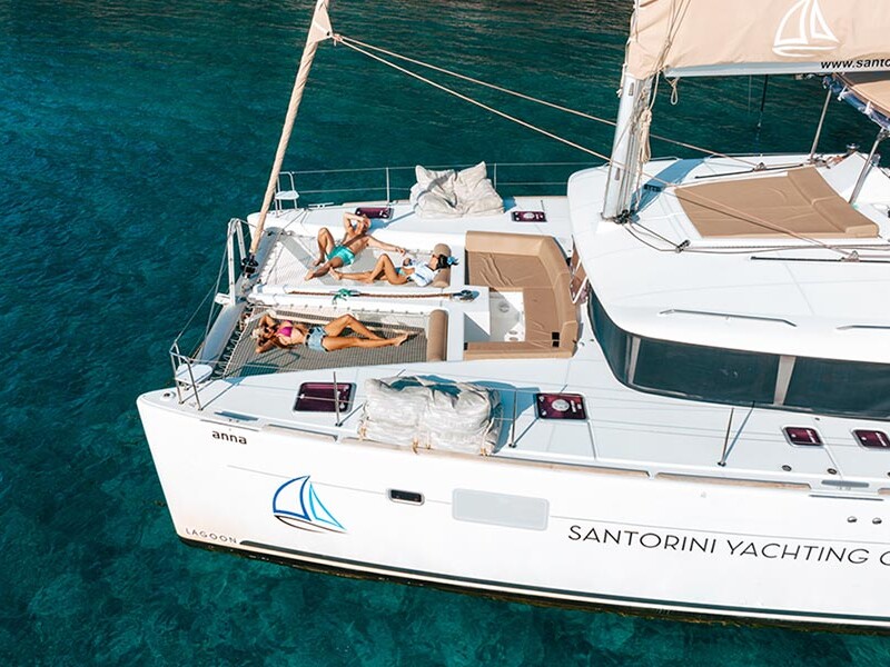 Friends sunbathing on Catamaran in Santorini