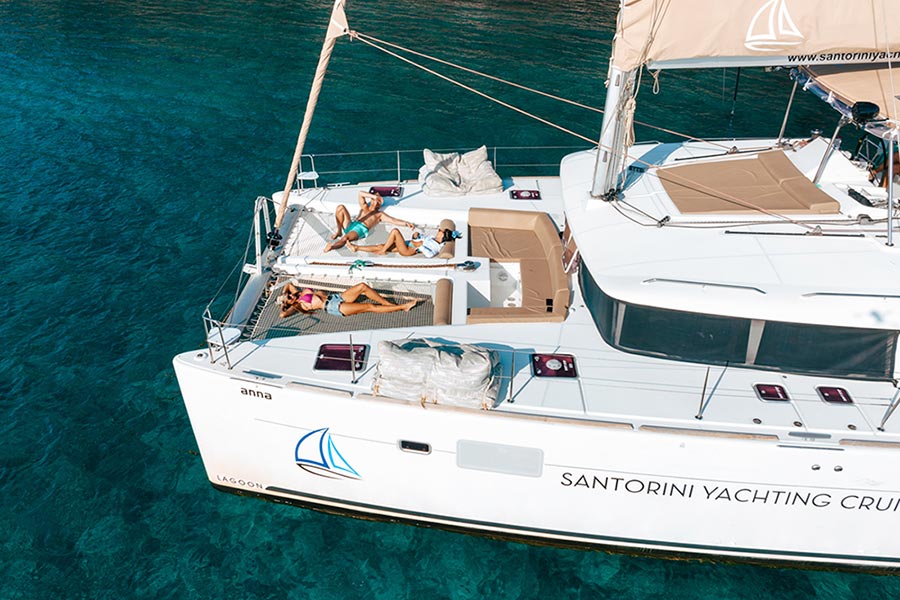 Friends sunbathing on Catamaran in Santorini
