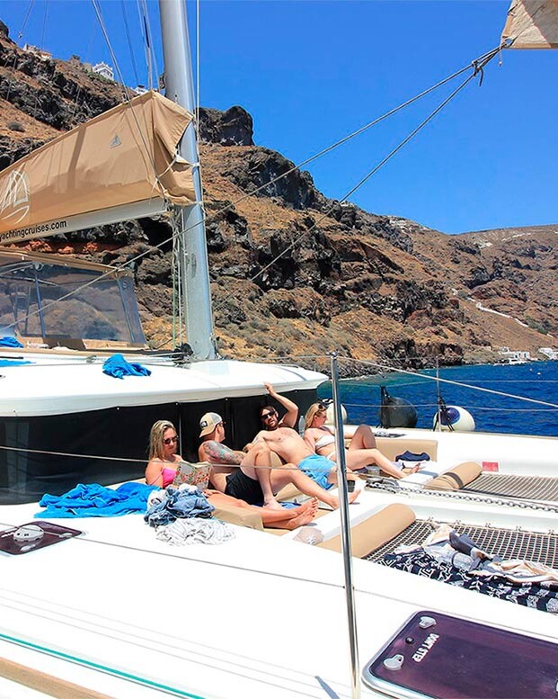 Group of friends on Catamaran in Santorini